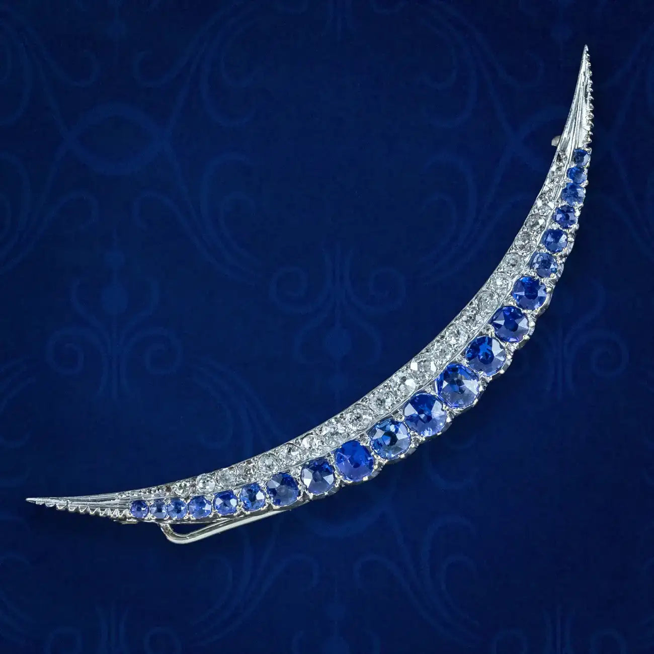 An Edwardian opal crescent shaped brooch