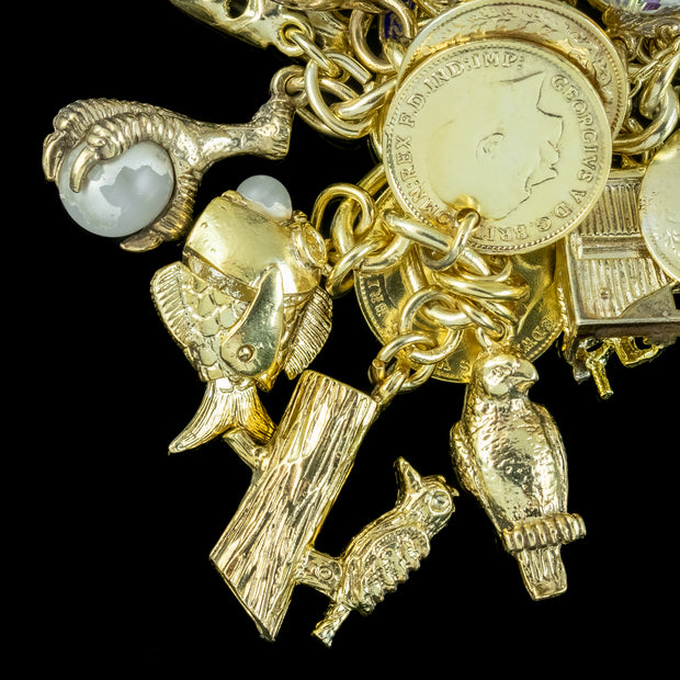 Lot - A vintage 18ct gold charm bracelet second quarter 20th century,